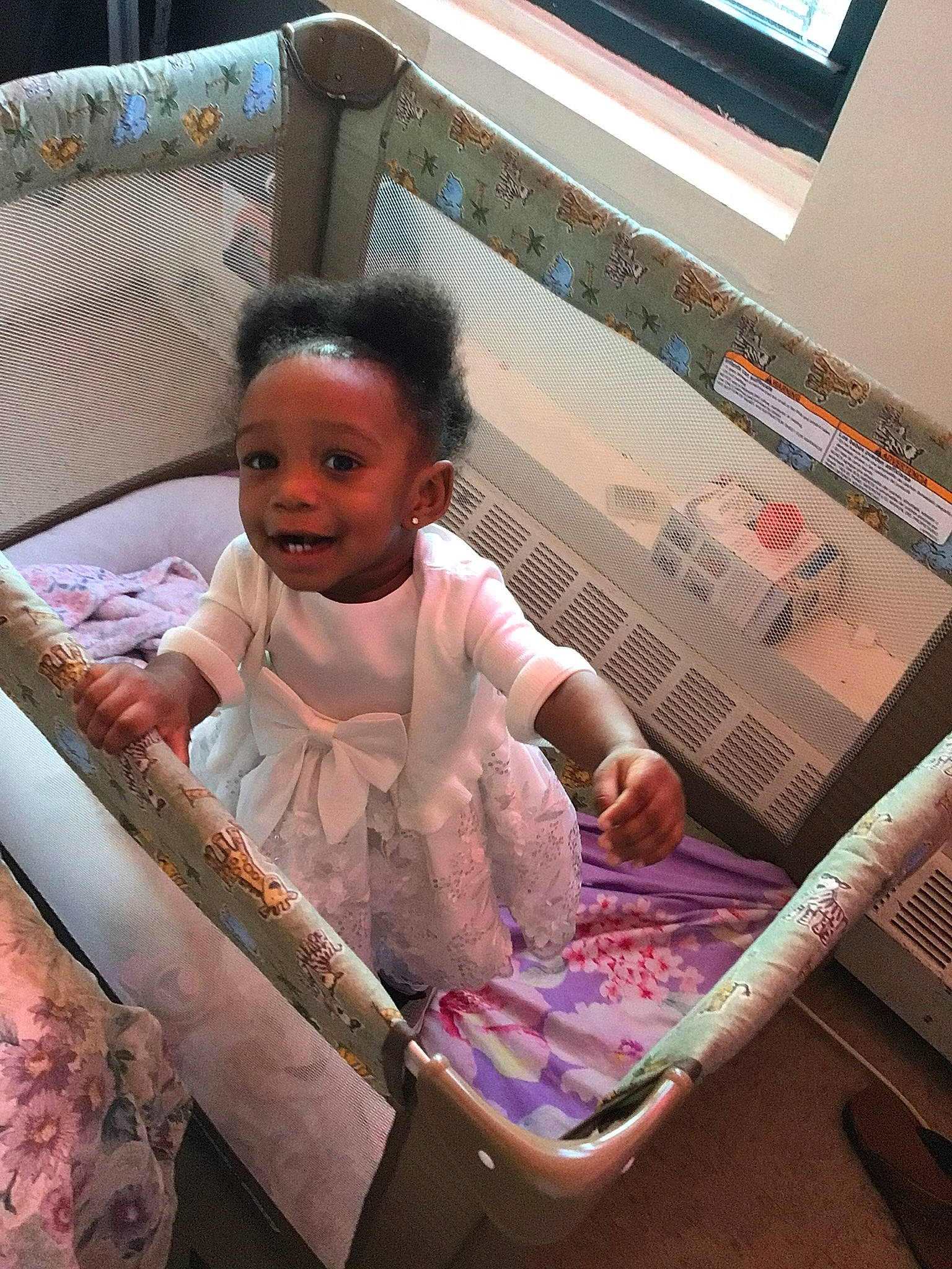 Arabella is registered to the contest to win money with this photo: baby, baby_products, baby_safety, baby_toddler_clothing, child, face, fun, hairstyle, happy, magenta, pattern, person, picture_frame, room, sitting, smile, toddler, vacation