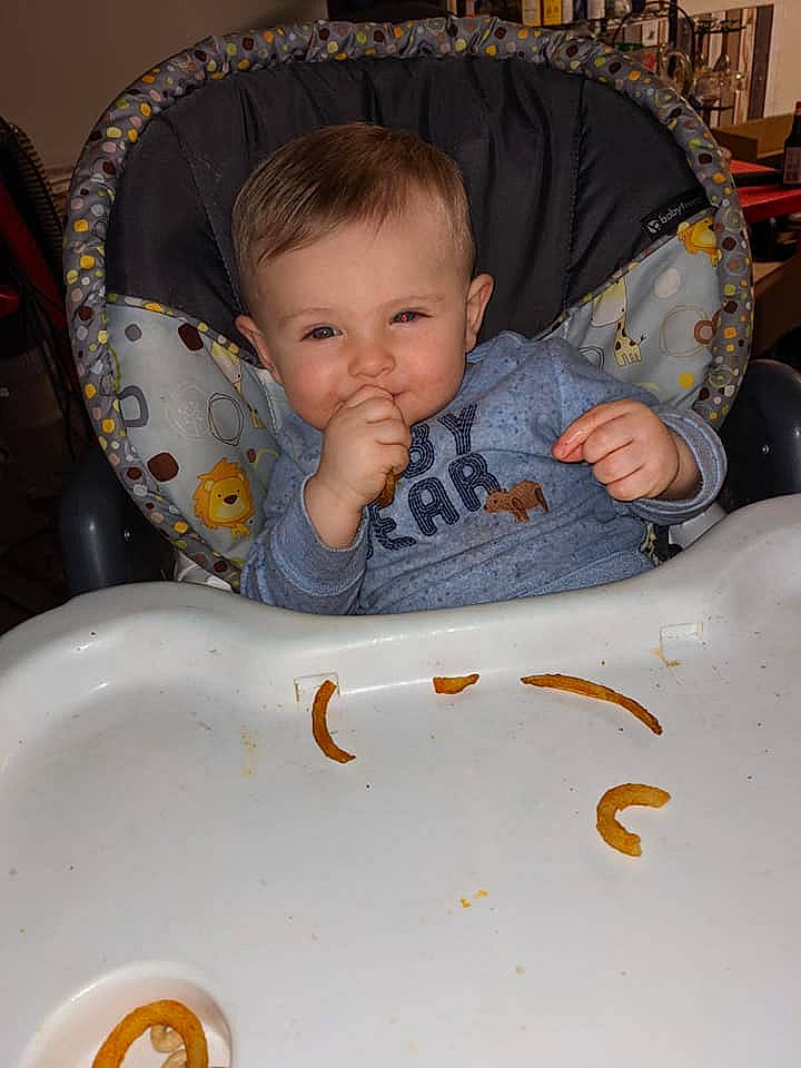 Jaxxon is registered to the contest to win money with this photo: baby, baby_products, baby_toddler_clothing, beauty, bib, chair, cheek, child, comfort, facial_expression, fun, hairstyle, head, human_body, iris, mouth, person, sitting, skin, sleeve