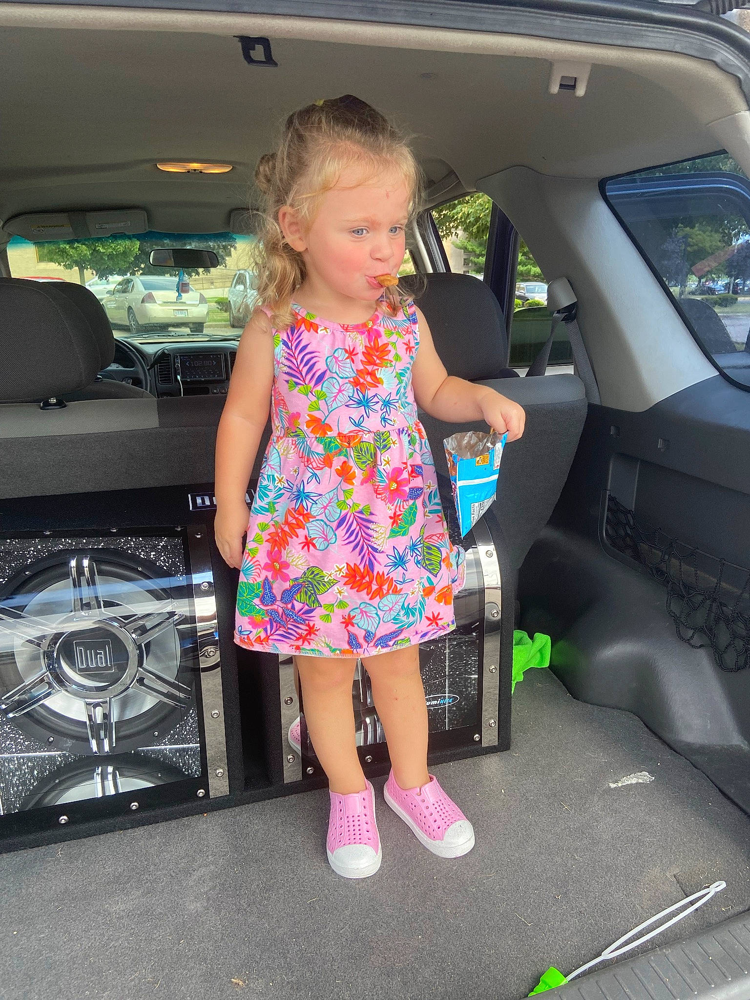 Lillian Daley is registered to the contest to win money with this photo: auto_part, automotive_design, automotive_exterior, automotive_lighting, beauty, bumper, car, dress, electric_blue, family_car, fun, human_leg, leisure, motor_vehicle, person, pink, thigh, toddler, trunk, vehicle
