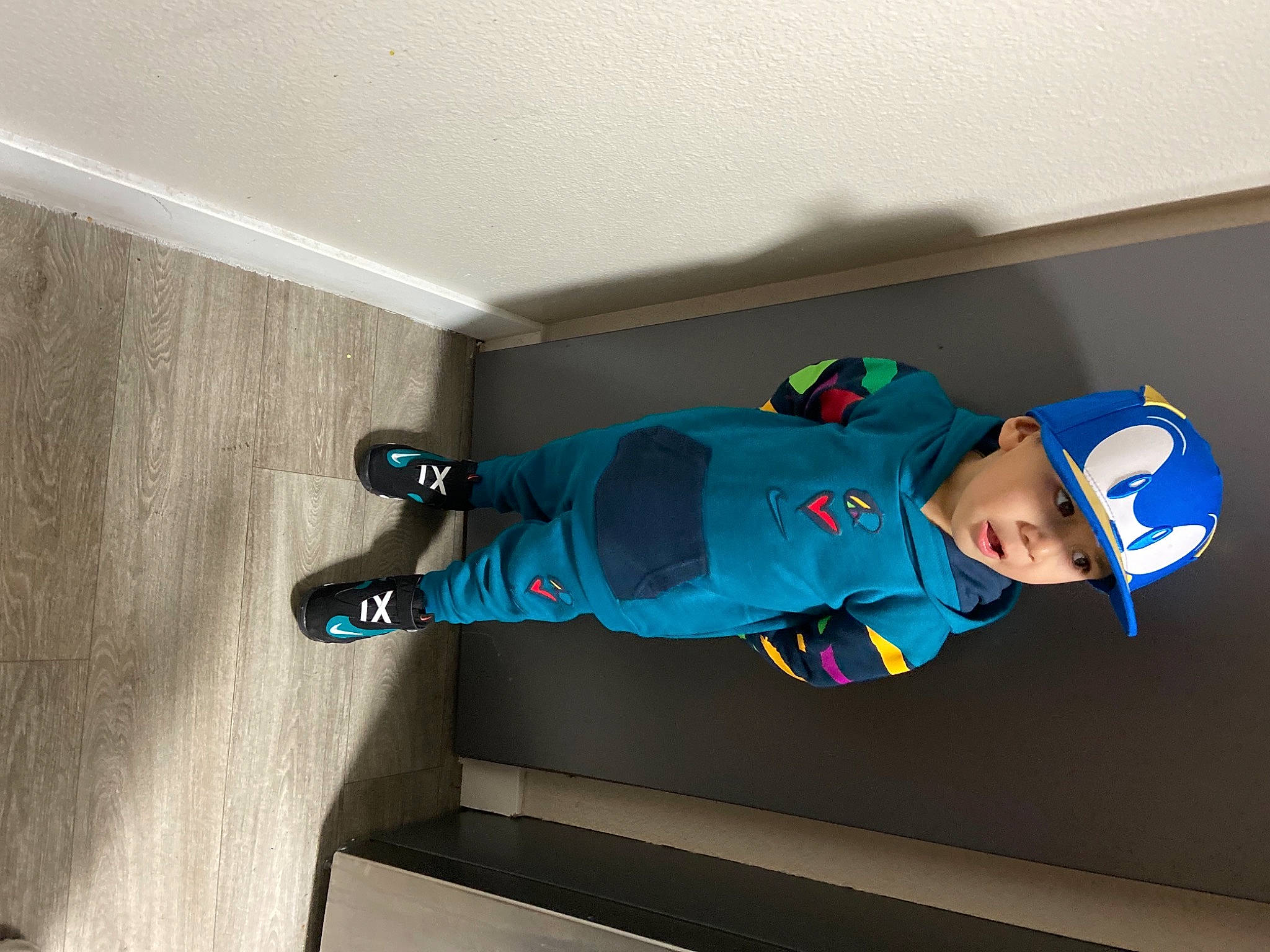 Jaden joined the competition — help win amazing prizes! baby, baby_toddler_clothing, baseball_cap, cap, ceiling, child, comfort, door, electric_blue, flooring, hardwood, hat, headwear, person, room, sleeve, smile, sportswear, stairs, t_shirt