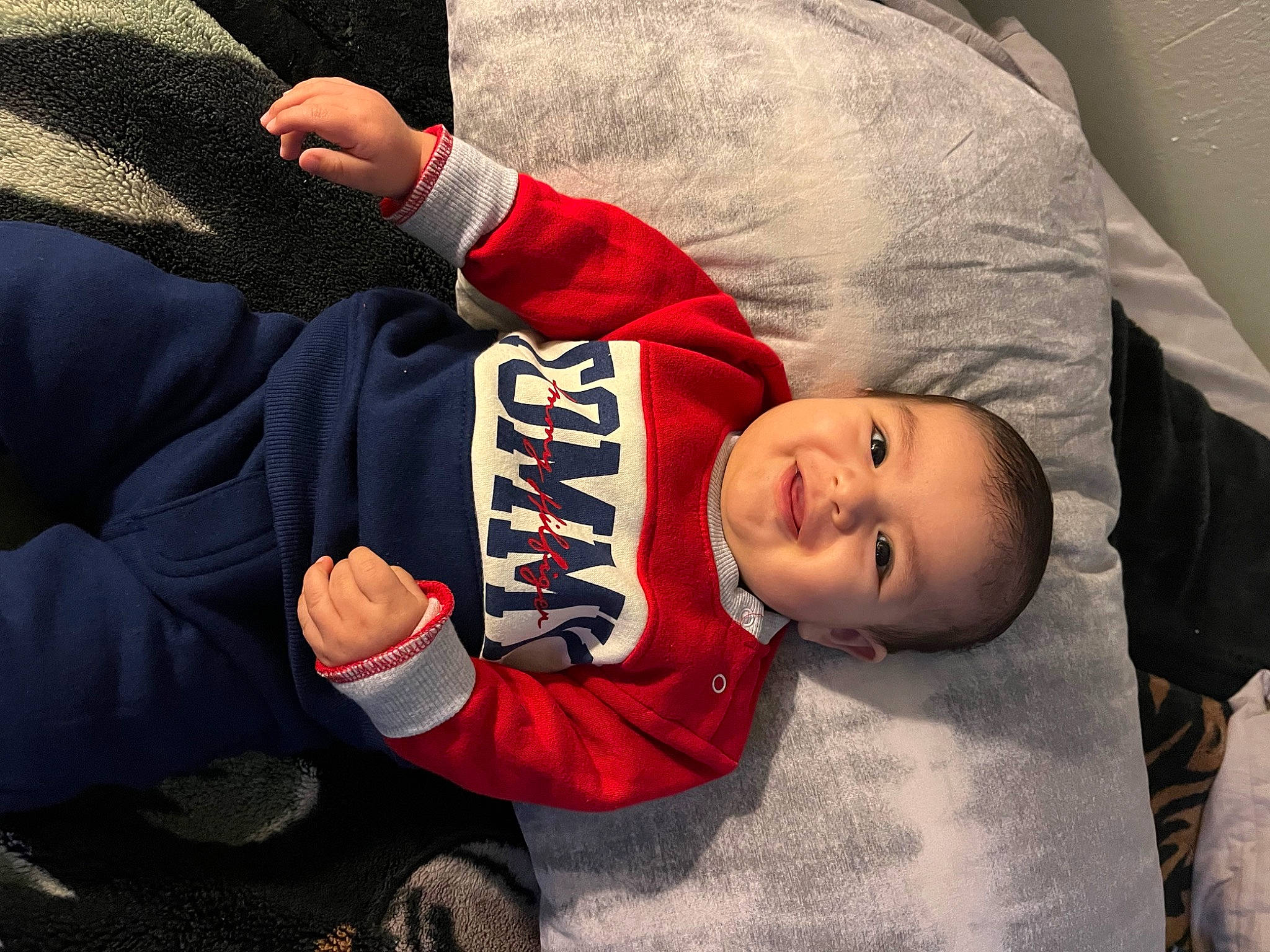 Giovanni is registered to the contest to win money with this photo: baby, baby_toddler_clothing, carmine, child, comfort, finger, gesture, happy, hat, headgear, joy, mouth, outerwear, person, sitting, sleeve, smile, thumb, tire, toddler