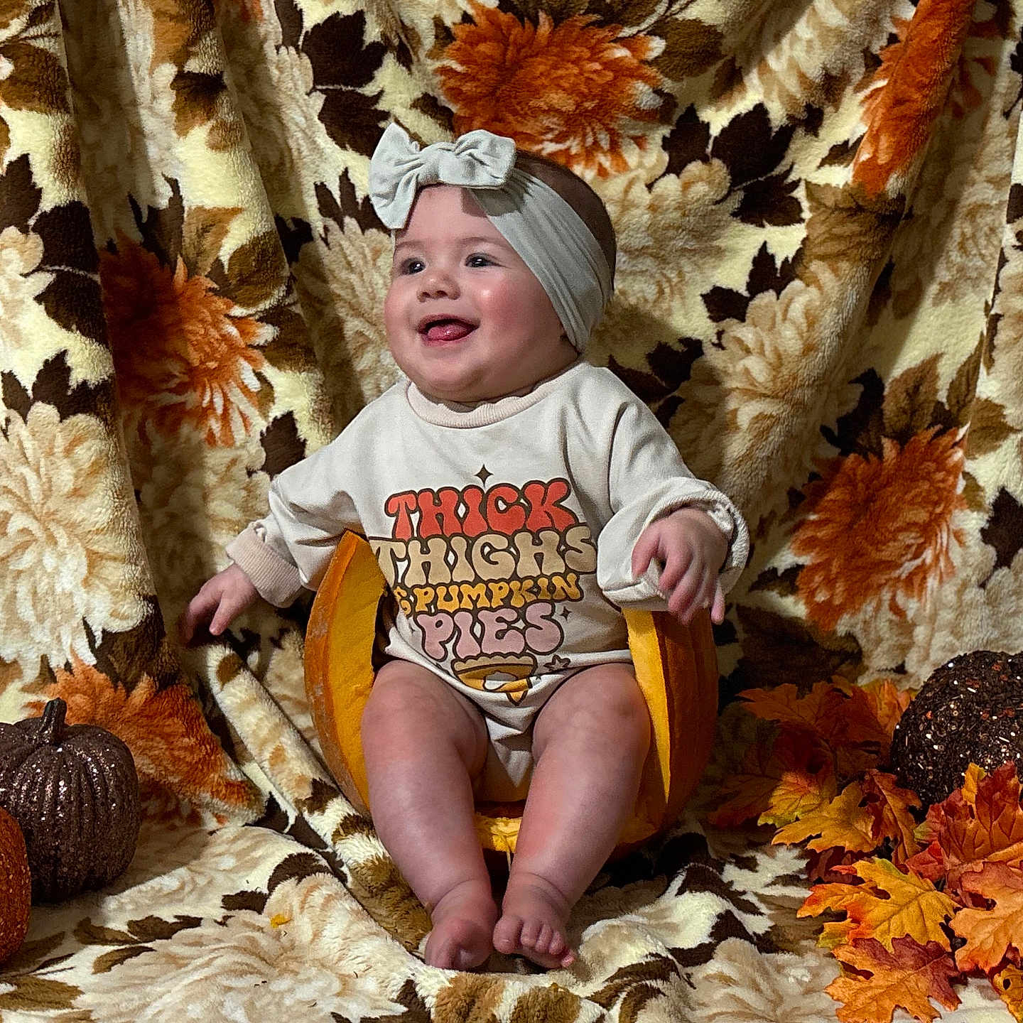 Bea joined the competition — help win amazing prizes! autumn, baby, blanket, child, clothing, cozy, cute, decor, fall_leaves, floral_pattern, glitter_pumpkins, happy, headband, indoors, orange, portrait, pumpkin, seasonal, sitting, smiling
