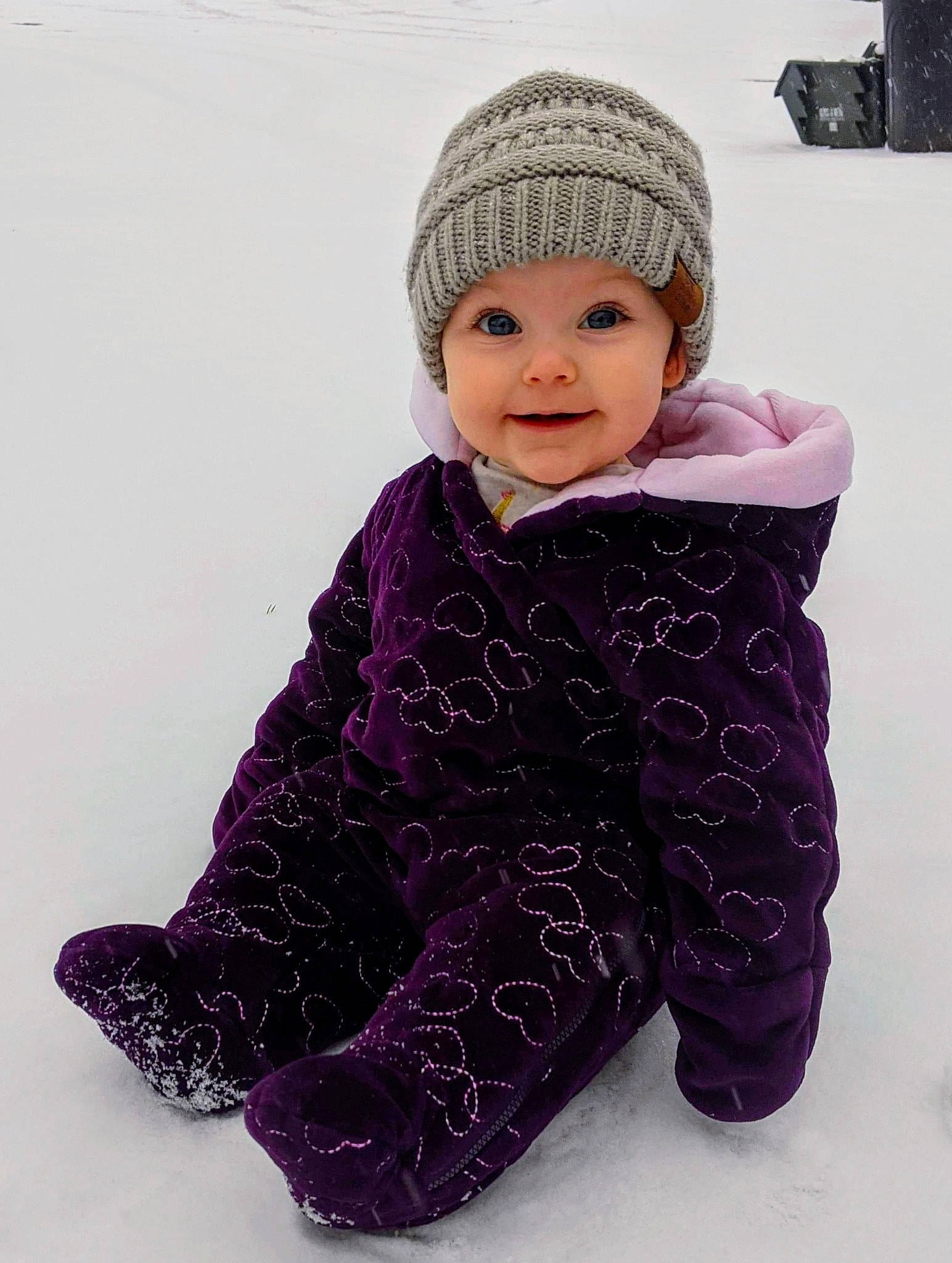 Colette is registered to the contest to win money with this photo: baby, baby_toddler_clothing, beauty, cap, cheek, clothing, face, headwear, jacket, joy, magenta, outerwear, pattern, person, pink, product, purple, sleeve, smile, snow