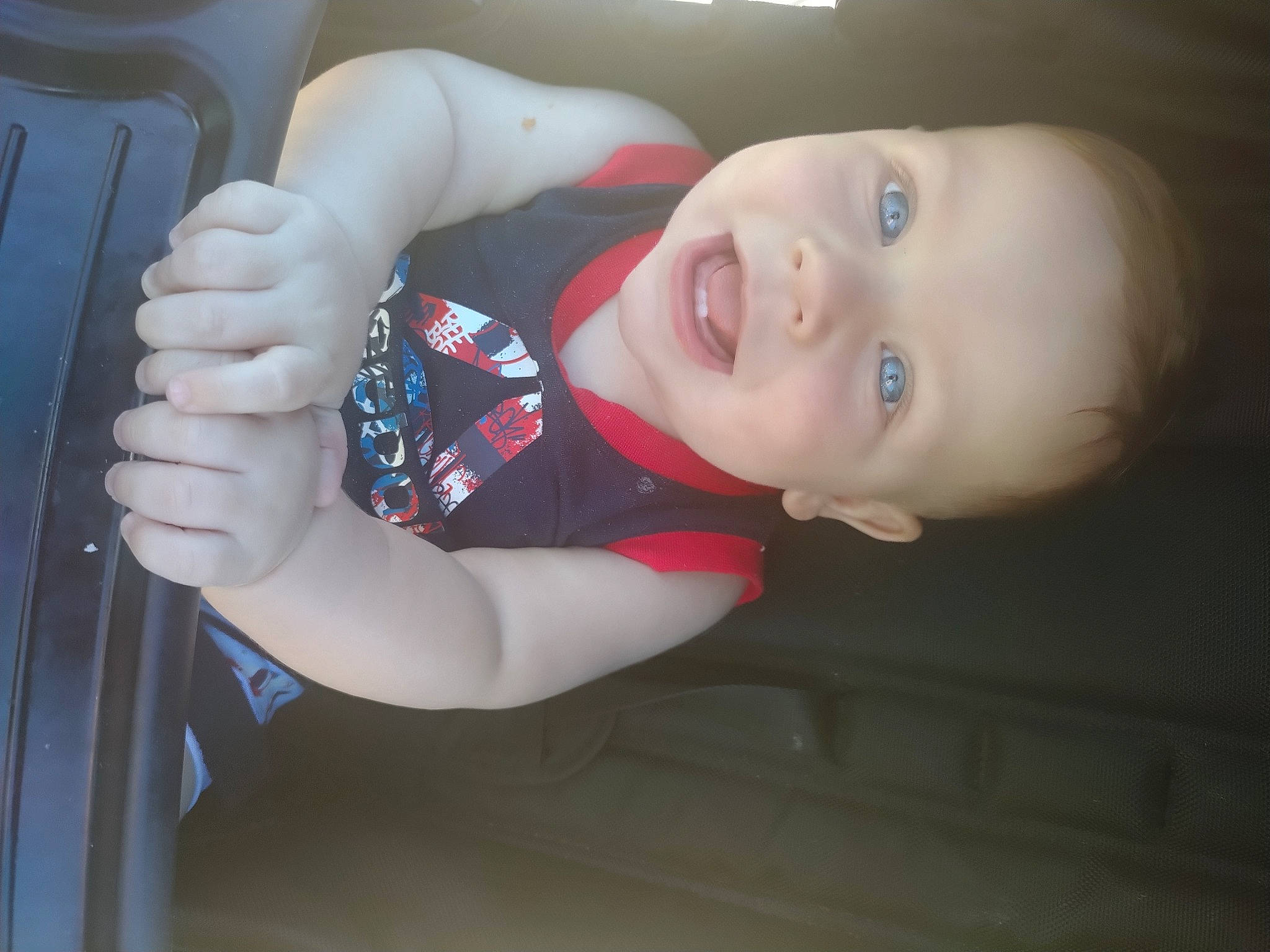 Westin is registered to the contest to win money with this photo: auto_part, baby, baby_products, baby_toddler_clothing, car_seat, child, comfort, elbow, eye, face, flash_photography, gesture, hair, nose, person, sleeve, smile, thumb, toddler, vehicle_door
