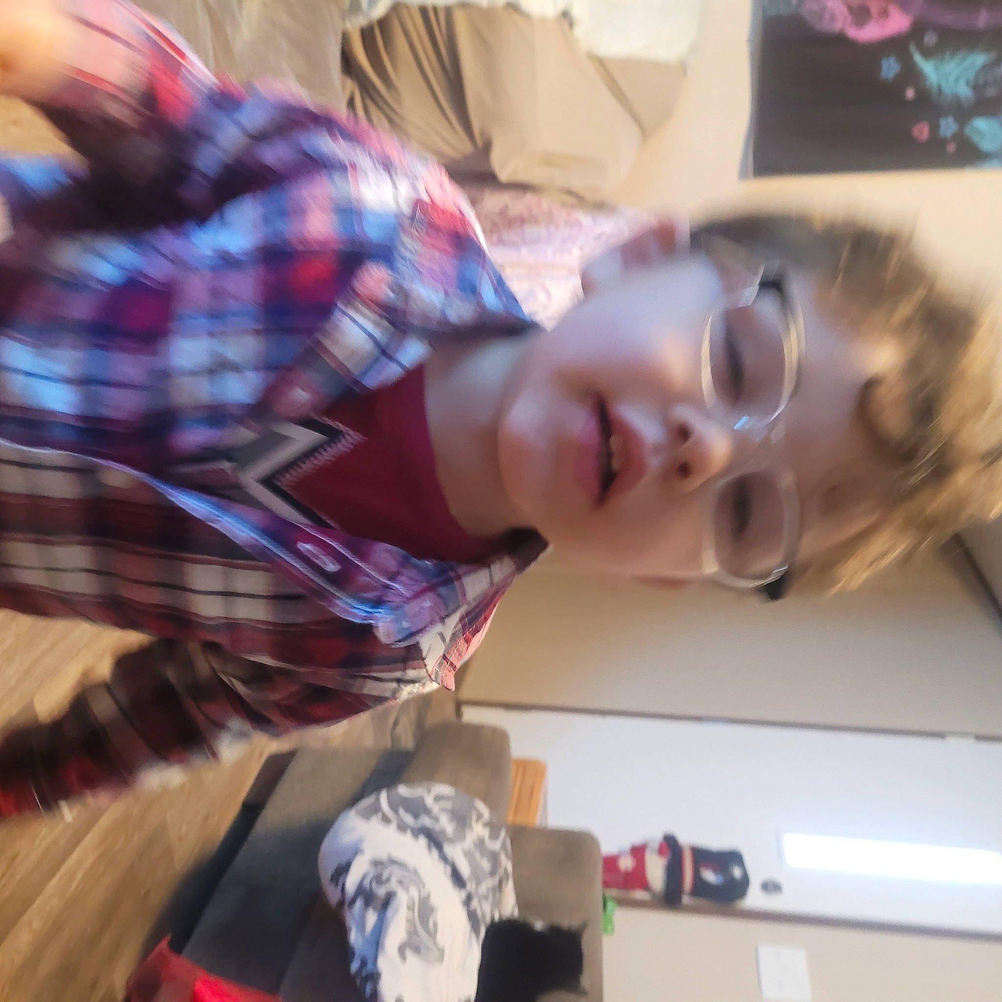 Jonathon is registered to the contest to win money with this photo: child, elbow, eyelash, eyewear, flooring, fun, hair_coloring, happy, jaw, pattern, person, plaid, room, smile, tartan, vacation, vision_care, wood