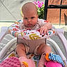 Everlee joined the competition — help win amazing prizes! baby, infant, baby_walker, plush_toy, pink_toy, pacifier, outdoor, sunlight, flower_pot, chair, colorful, patterned_fabric, serious_expression, child, toddler, seat, legs, hand, head, person