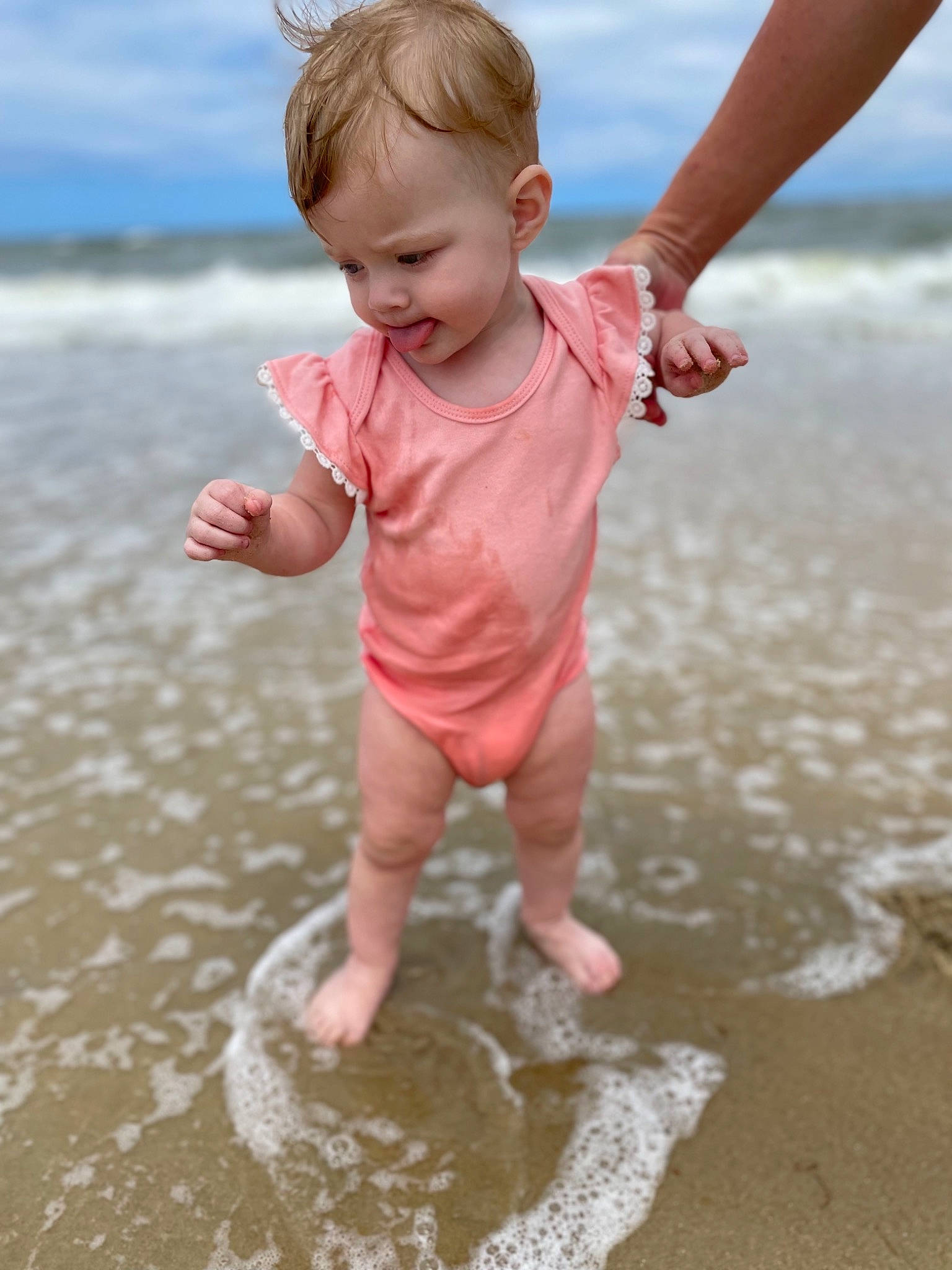 Evalynn joined the competition — help win amazing prizes! arm, baby_toddler_clothing, barefoot, beach, child, cloud, finger, fun, gesture, hand, happy, human_body, leg, people_in_nature, people_on_beach, person, sky, standing, summer, toddler