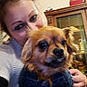 Tokyo a rejoint le concours — aidez-le/la à gagner de superbes lots ! woman, dog, indoor, pet, sweater, hug, cabinet, glass, brown_dog, closeup, portrait, home, furniture, smile, cozy, casual_clothing, friendly, companion, cute, warm