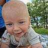Atlas joined the competition — help win amazing prizes! adult, baby, baby_clothing, blanket, blue_eyes, blue_shirt, child, close_up, crawling, face, family, grass, happy, infant, outdoor, park, portrait, smiling, sunlight, trees