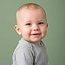 Rocco joined the competition — help win amazing prizes! baby, smiling, face, child, portrait, cute, infant, toddler, clothing, grey_shirt, skin, head, eyes, ear, background, green_background, happy, young_child, indoor, studio