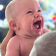 Rocco is registered to the contest to win money with this photo: baby, child, smiling, happy, person, infant, skin, hand, arm, tattoo, indoor, portrait, closeup, expression, cute, joy, parent, family, blurred_background, holding