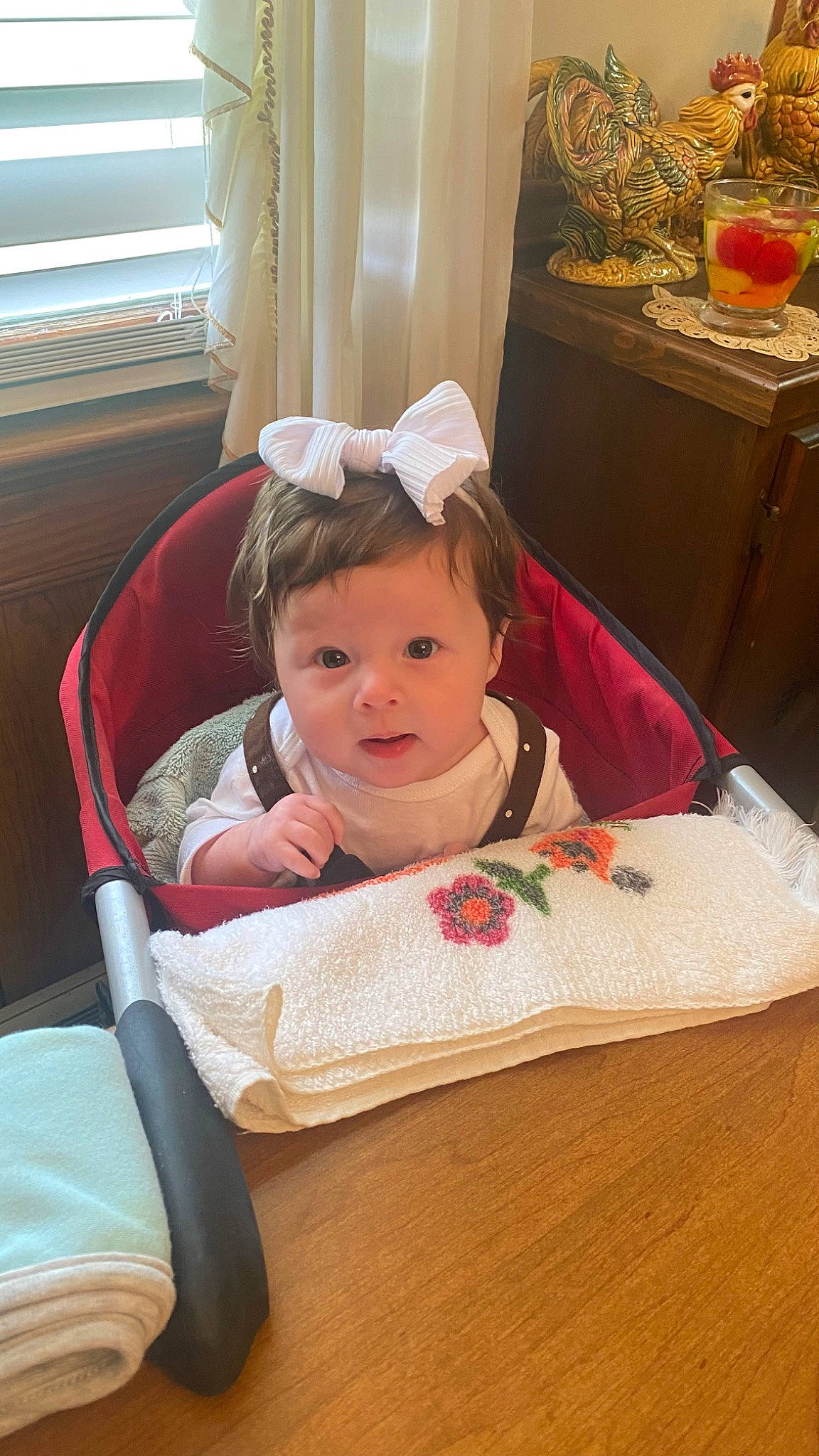 Camryn joined the competition — help win amazing prizes! baby, baby_products, baby_toddler_clothing, bib, chair, cheek, child, clementine, comfort, flooring, fruit, head, juice, lap, person, room, sitting, toddler, valencia_orange, window