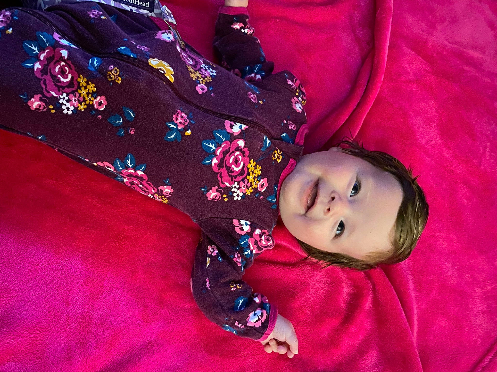 Camryn joined the competition — help win amazing prizes! baby, baby_toddler_clothing, carmine, child, comfort, electric_blue, flooring, joy, linens, magenta, pattern, person, pink, purple, room, sitting, sleeve, smile, textile, toddler