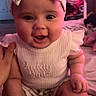Sariyah is registered to the contest to win money with this photo: baby, child, infant, girl, headband, bow, smiling, happy, cute, clothing, sitting, hand, room, bed, blanket, person, portrait, indoor, skin, face