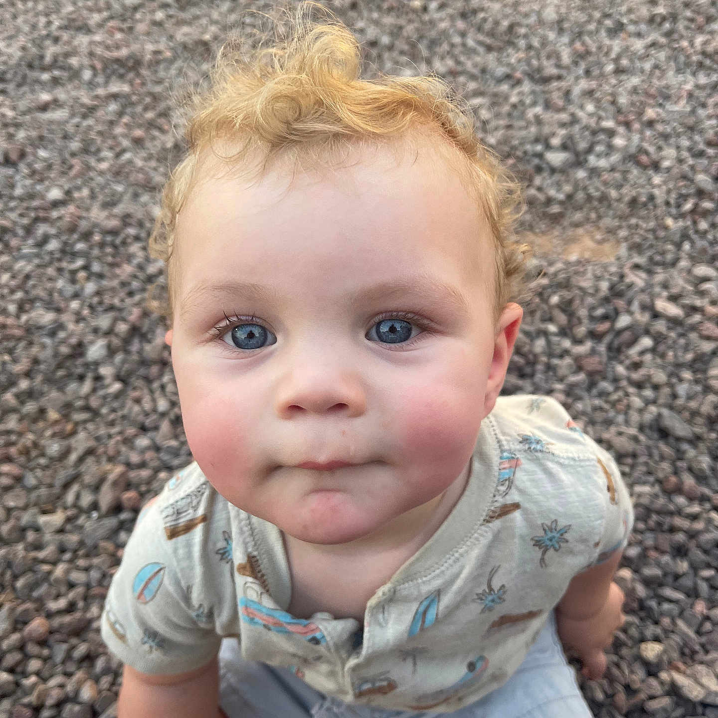 Greyson is registered to the contest to win money with this photo: baby, blonde, city, clothing, crawling, face, gravel, hair, happy, head, jeans, pants, pebble, person, photography, portrait, road, rock, sitting, smile