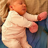 Zoey is registered to the contest to win money with this photo: baby, bed, blanket, close_up, cozy, cute, earring, fabric_texture, infant, newborn, nursery, pajamas, peaceful, pillow, pink_mittens, portrait, resting, sleeping, sock_booties, soft_lighting