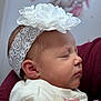 Zoey is registered to the contest to win money with this photo: adult_arm, arm, baby, cheeks, close_up, earring, face, flower, headband, infant, lace, newborn, nursery_wall, pink, portrait, profile, sleeping, soft_light, sweater, wall_art