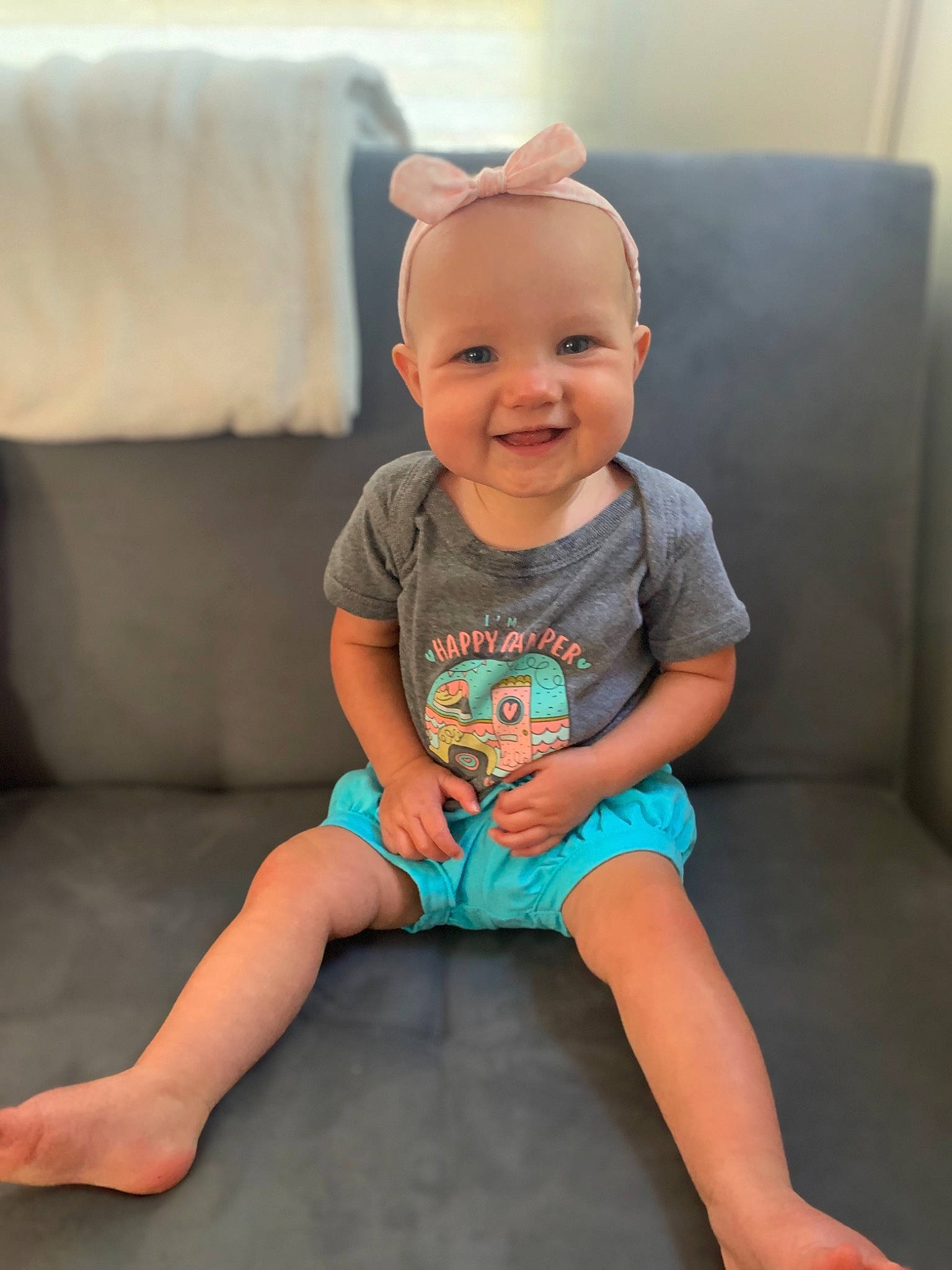 Harlee joined the competition — help win amazing prizes! baby, baby_toddler_clothing, blue, cheek, child, face, fun, head, joy, knee, leg, person, pink, sitting, skin, sleeve, smile, standing, t_shirt, toddler