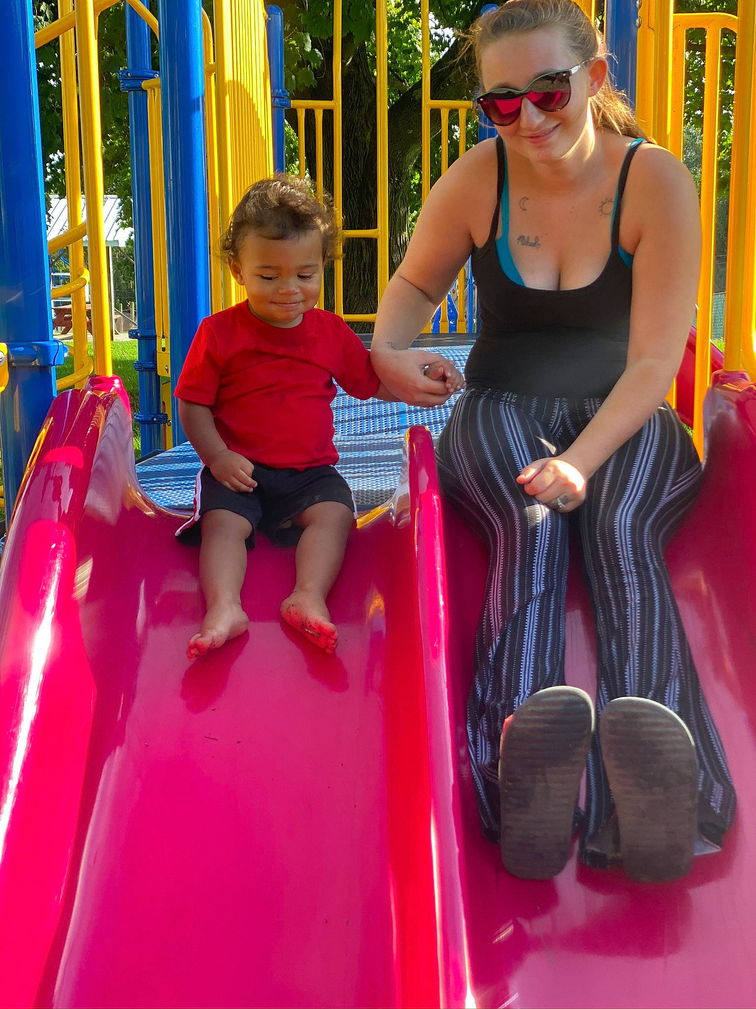 Cj is registered to the contest to win money with this photo: blue, chute, city, eyewear, fun, goggles, joy, leisure, magenta, person, pink, playground, public_space, recreation, red, snapshot, summer, sunglasses, thigh, toddler