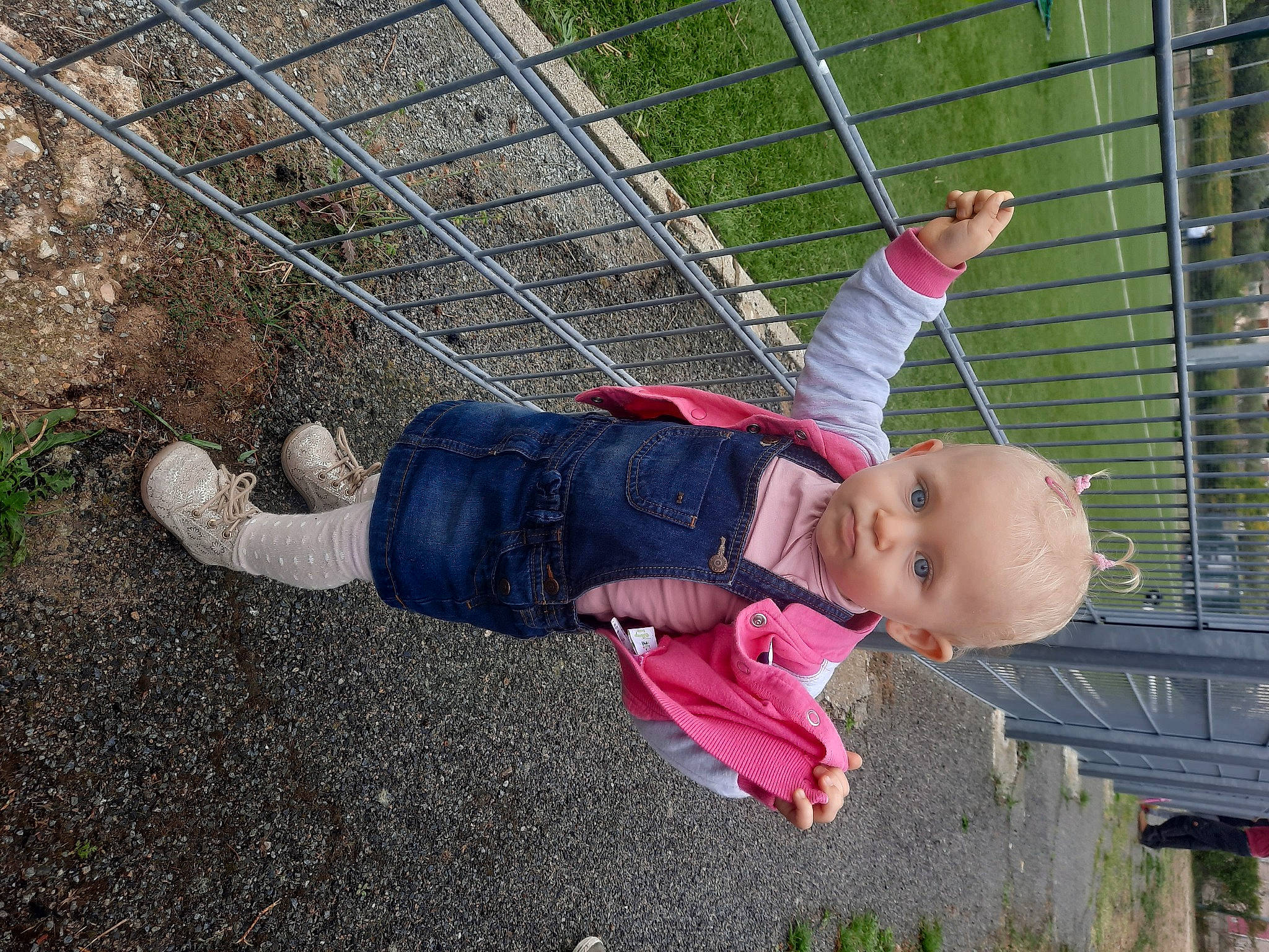 Célina participe au concours pour gagner de l'argent avec cette photo : chain_link_fencing, child, fence, fun, grass, leaf, leisure, mesh, net, people_in_nature, person, plant, play, recreation, rope, smile, sneakers, toddler, walking_shoe