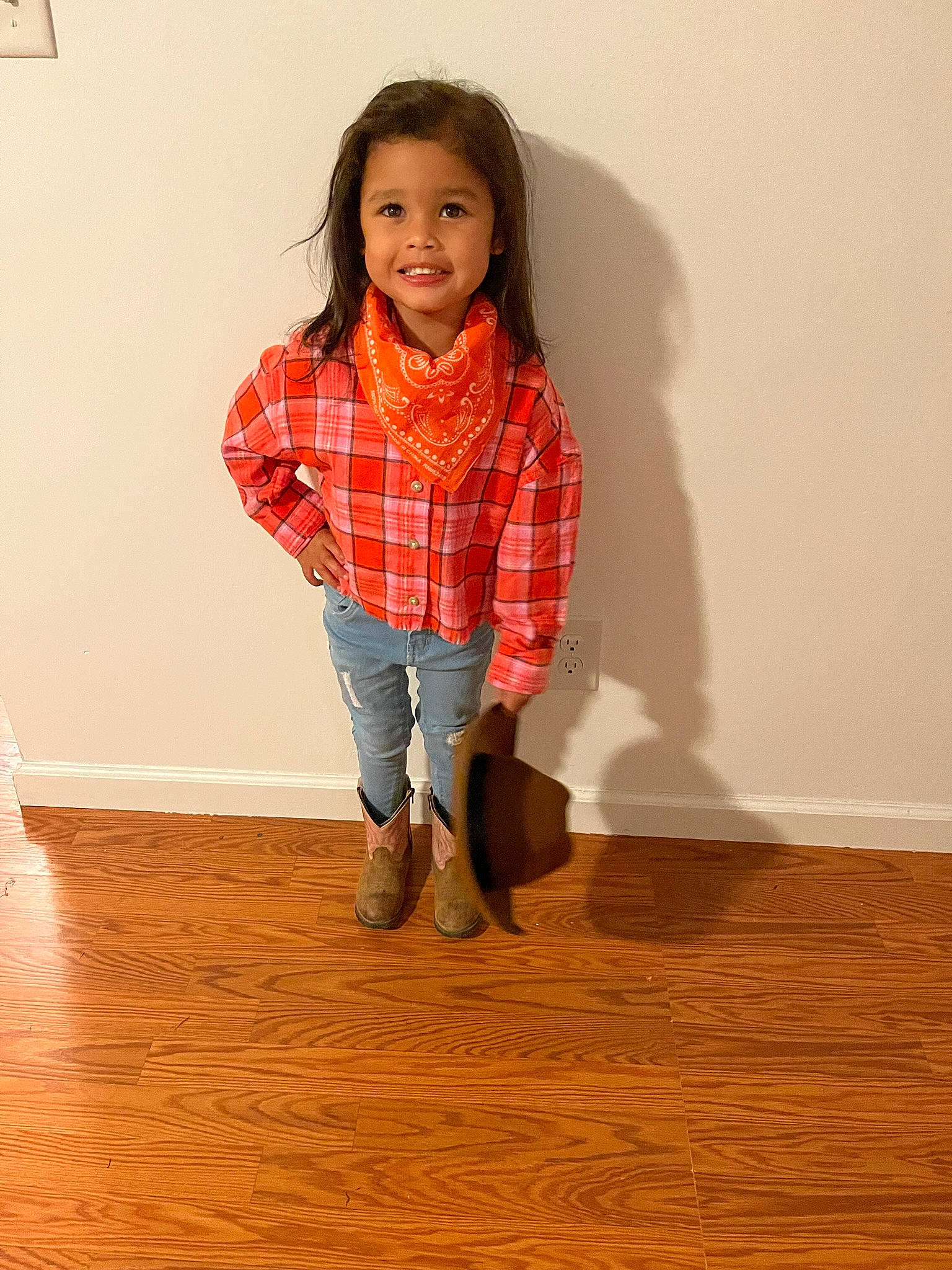 Lamya is registered to the contest to win money with this photo: arm, collar, dress_shirt, face, floor, flooring, hair, happy, hardwood, head, jeans, joy, knee, leg, neck, person, plaid, shoe, sleeve, smile