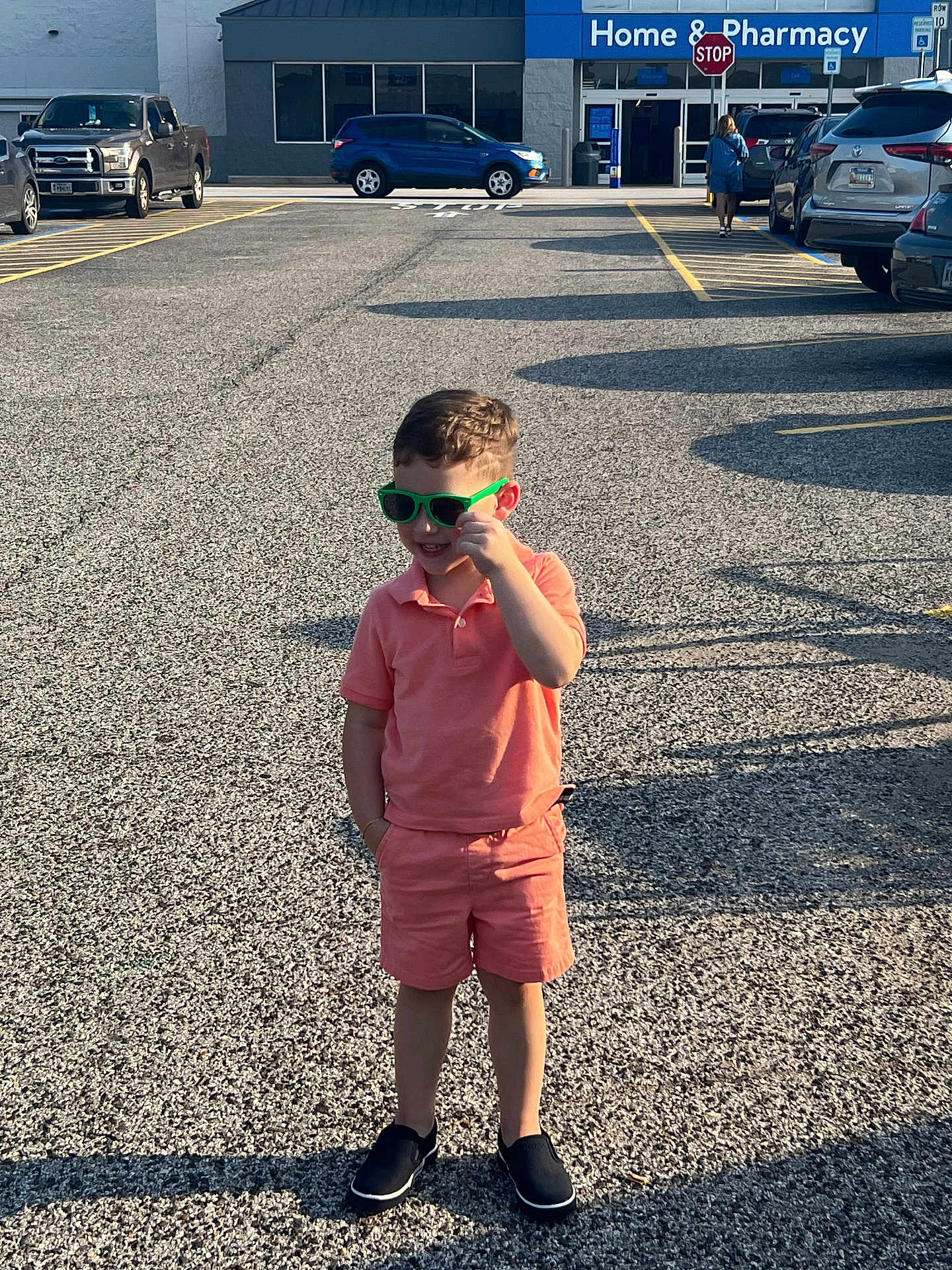 Matthew joined the competition — help win amazing prizes! child, boy, sunglasses, parking_lot, car, sidewalk, shadow, casual_clothing, shorts, polo_shirt, footwear, sunlight, storefront, stop_sign, road_marking, outdoor, daytime, person, smile, green_sunglasses