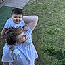 Remington is registered to the contest to win money with this photo: child, toddler, adult, outdoor, grass, sidewalk, shoulder_ride, smile, casual_clothing, white_tshirt, greenery, daylight, happy, playful, person, short_hair, footwear, nature, family, interaction