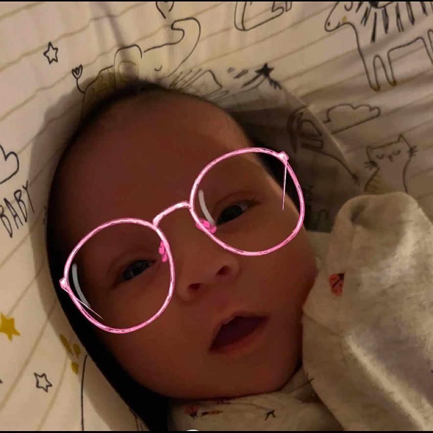 Graylee joined the competition — help win amazing prizes! animal_drawings, baby, blanket, child, clothing, cozy, cute, digital_effect, expression, eyes, face, glasses_filter, head, indoors, infant, lying_down, mouth, portrait, skin, soft_lighting