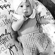 Skyler joined the competition — help win amazing prizes! baby, infant, child, bow, headwear, pillow, text, words, love, joy, smile, clothing, cute, indoors, monochrome, black_and_white, person, portrait, sitting, floor