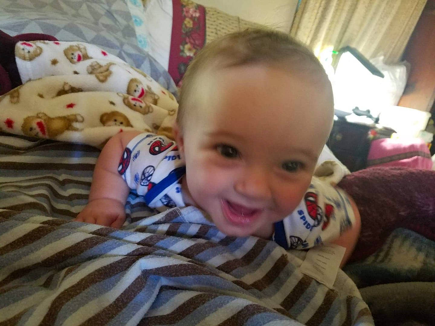 Greysen is registered to the contest to win money with this photo: baby, bedtime, cheek, child, ear, eye, face, finger, hand, head, iris, mouth, nose, person, play, skin, smile, toddler