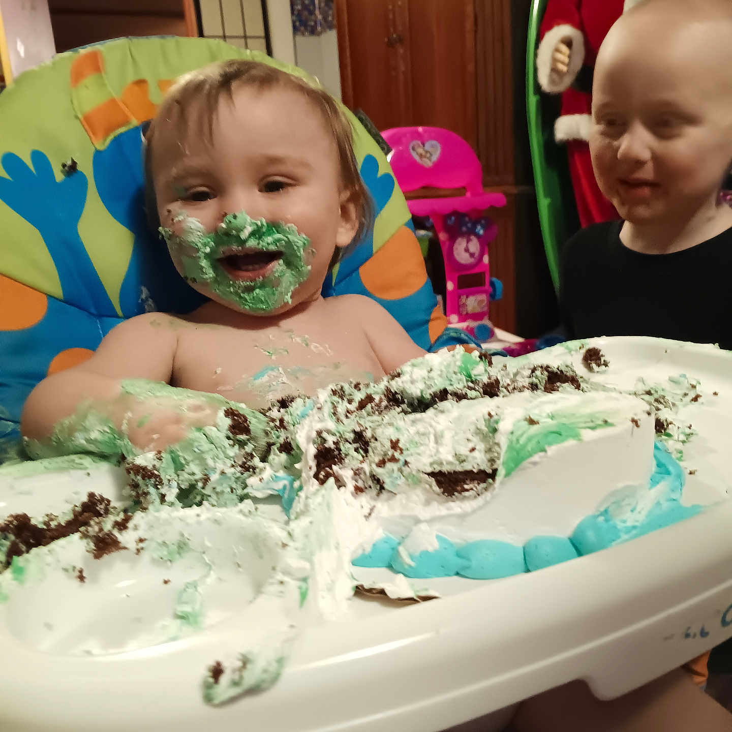 Dexter is registered to the contest to win money with this photo: baby, birthdaycake, bodypart, cake, clothing, cream, dessert, face, finger, food, furniture, hand, hat, head, icecream, icing, person, photography, portrait, sweets