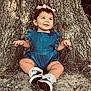 baby, child, cute, denim, grass, ground, happy, nature, outdoor, person, pink_bow, portrait, romper, shoes, sitting, smile, socks, sunlight, tree, young_child