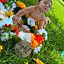 baby, infant, child, grass, flowers, yellow_outfit, outdoor, nature, greenery, daisy, orange_flower, white_flower, cute, portrait, smiling, summer, sunlight, happy, playful, eight_months