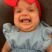Remy is registered to the contest to win money with this photo: baby, child, smiling, red_bow, headband, blue_dress, cute, happy, portrait, infant, sitting, indoors, fashion, person, young_child, closeup, face, skin, clothing, chubby_cheeks
