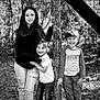 black_and_white, boy, casual_clothing, child, children, daylight, forest, girl, happy, jeans, laughing, long_hair, nature, outdoor, playful, portrait, short_hair, sibling, smiling, tree
