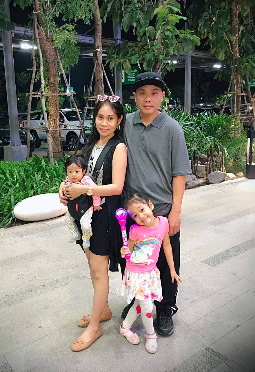 Angelina is registered to the contest to win money with this photo: cap, child, event, fun, garden, happy, hat, headwear, joy, leisure, person, pink, plant, recreation, sandal, sitting, street, sun_hat, toddler, tourism