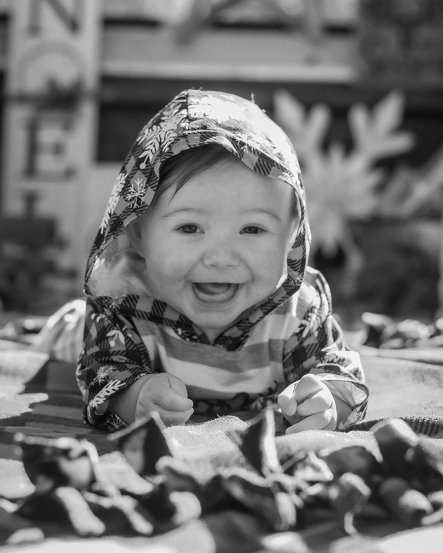 Kaycee is registered to the contest to win money with this photo: baby, black, black_and_white, eye, face, flash_photography, fun, grass, happy, headgear, headwear, human, joy, leaf, monochrome, monochrome_photography, people_in_nature, person, skin, smile