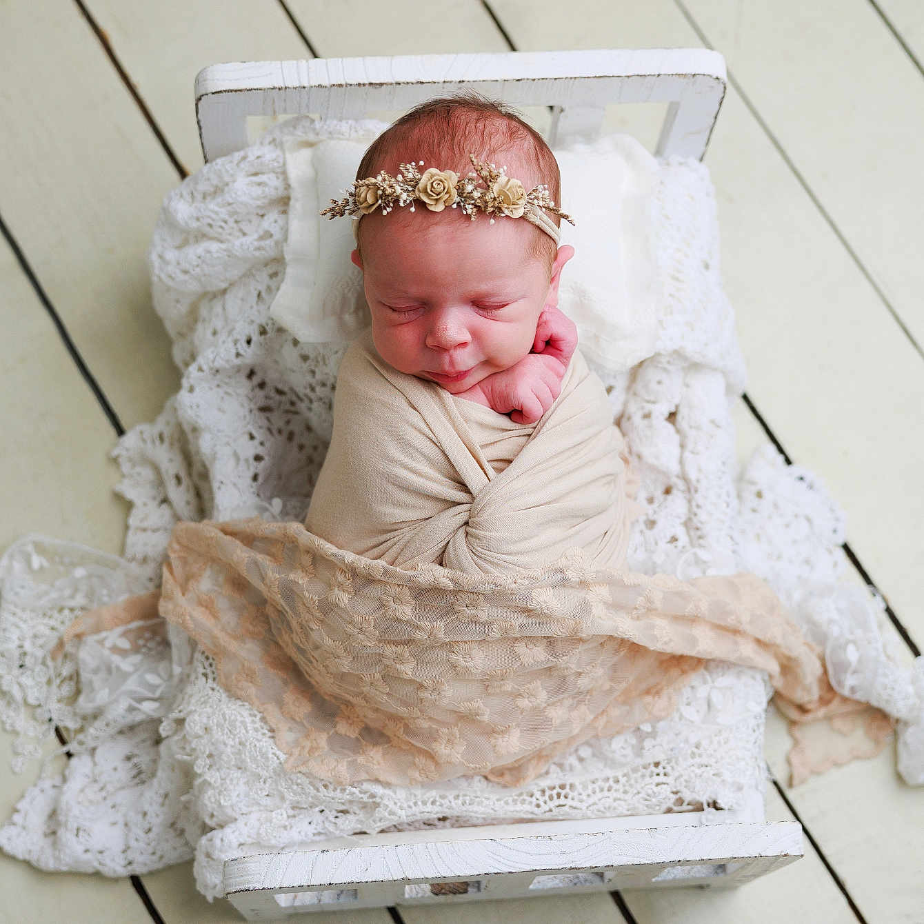 Eloisa is registered to the contest to win money with this photo: baby, bed, cozy, cute, delicate, flower_crown, headband, infant, lace_blanket, newborn, peaceful, portrait, resting, sleeping, small_bed, soft_texture, swaddle, white_bed, wooden_floor, wrapped