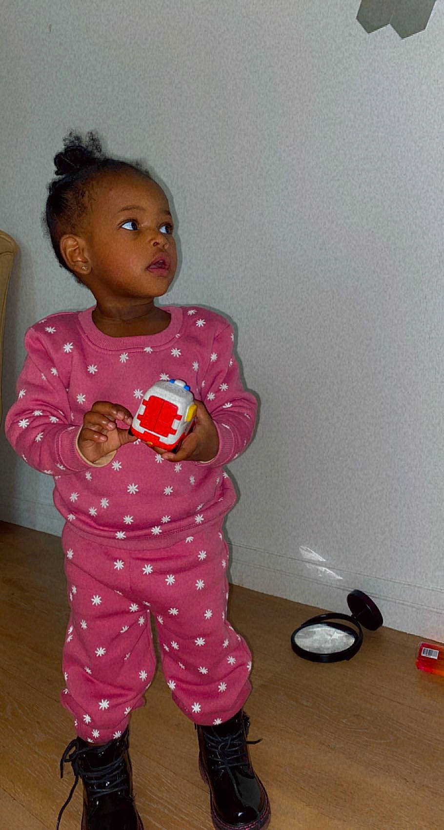 Alayna participe au concours pour gagner de l'argent avec cette photo : afro, baby_toddler_clothing, baby_toys, carmine, cheek, child, doll, eye, fashion_design, flooring, flowerpot, head, magenta, pajamas, pattern, person, pink, sleeve, t_shirt, toddler