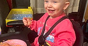 Emilia joined the competition — help win amazing prizes! cake, child, curtain, face, food, frosting, furniture, hand, happy, high_chair, indoor, messy, person, pink_sweatshirt, plate, pony_tail, seat_belt, smiling, table, toddler