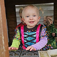 Emilia is registered to the contest to win money with this photo: toddler, child, costume, dress, pigtails, smile, face, hands, background, children, green_outfit, polka_dot, play, happy, indoors, cartoon_bat, fun, party, colorful, portrait
