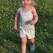 Emilia is registered to the contest to win money with this photo: blonde, casual_clothing, child, clover, daytime, field, grass, happy, nature, outdoor, person, play, romper, running, shoes, smiling, summer, sunlight, toddler, young
