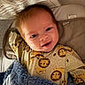 Colt joined the competition — help win amazing prizes! baby, infant, child, smiling, portrait, face, eyes, blond_hair, seated, baby_seat, blanket, blue_blanket, lion_pattern, clothing, indoor, cozy, newspaper, fabric, happy, photography