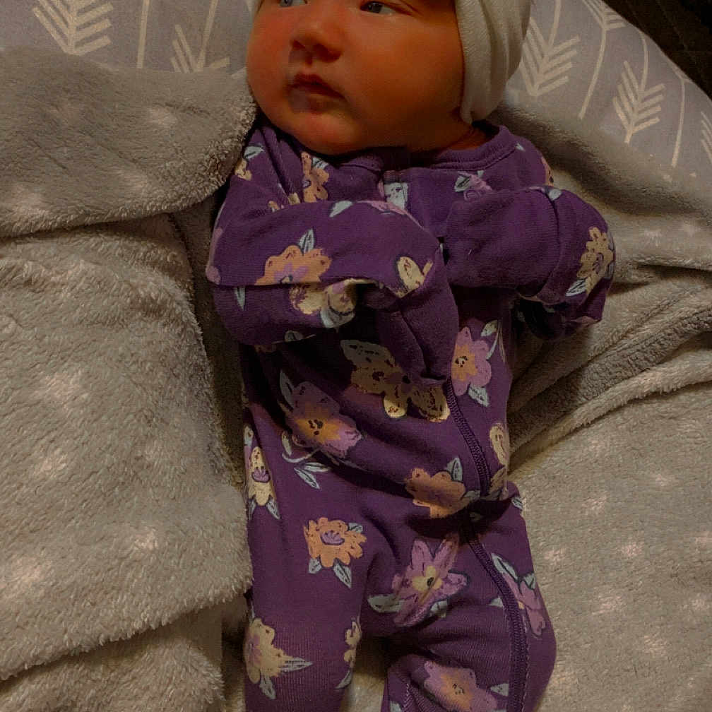 Raelynn joined the competition — help win amazing prizes! baby, bed, blanket, bonnet, cap, clothing, couch, doll, dress, face, fashion, formalwear, furniture, gown, hat, head, pajamas, person, quilt, toy