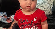 Ember joined the competition — help win amazing prizes! baby, child, infant, red_shirt, sitting, indoor, couch, pillow, blanket, cute, face, portrait, clothing, person, home, soft_lighting, expression, looking_at_camera, toddler, short_hair
