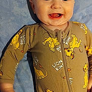 Jaxon is registered to the contest to win money with this photo: baby, child, smiling, blue_blanket, onesie, lion_king, cartoon, happy, face, infant, cute, sleepwear, hands, lying_down, mouth_open, bright_eyes, skin, young, childwear, portrait