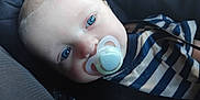 Jaxon is registered to the contest to win money with this photo: baby, child, face, blue_eyes, pacifier, striped_shirt, seatbelt, closeup, infant, person, clothing, portrait, head, resting, young_child, indoor, cute, baby_boy, comfort, car_seat