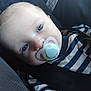 baby, child, face, blue_eyes, pacifier, striped_shirt, seatbelt, closeup, infant, person, clothing, portrait, head, resting, young_child, indoor, cute, baby_boy, comfort, car_seat