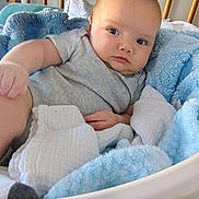 Jesse is registered to the contest to win money with this photo: baby, infant, blanket, basket, blue_blanket, white_blanket, crib, nursery, child, person, indoor, cozy, soft, resting, looking, cute, comfortable, newborn, clothing, relaxed