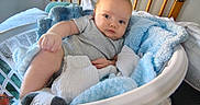 Jesse is registered to the contest to win money with this photo: baby, basket, blanket, blue_blanket, child, clothing, comfortable, cozy, crib, cute, indoor, infant, looking, newborn, nursery, person, relaxed, resting, soft, white_blanket